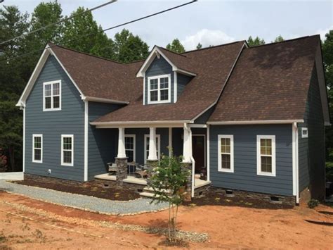 brick house with brown metal roof|brick and shingle combinations.